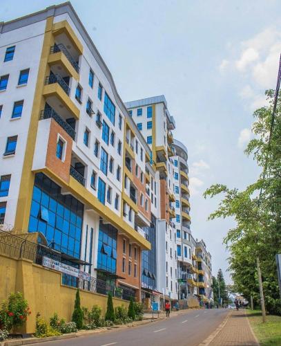 a row of tall buildings on a city street at Tropical Plaza Apartments in Kigali