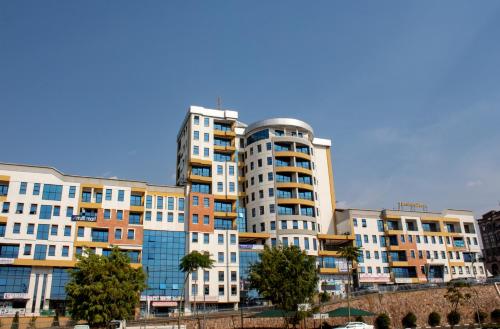 a group of tall buildings in a city at Tropical Plaza Apartments in Kigali
