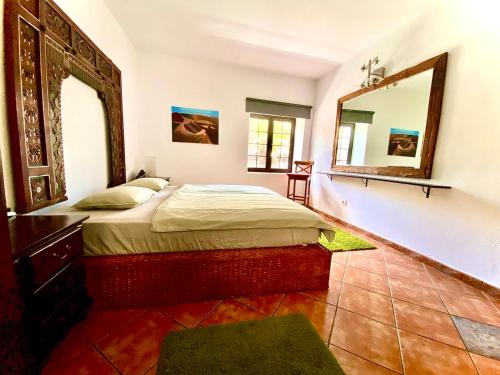 a bedroom with a bed and a large mirror at Pure La Asomada in La Asomada