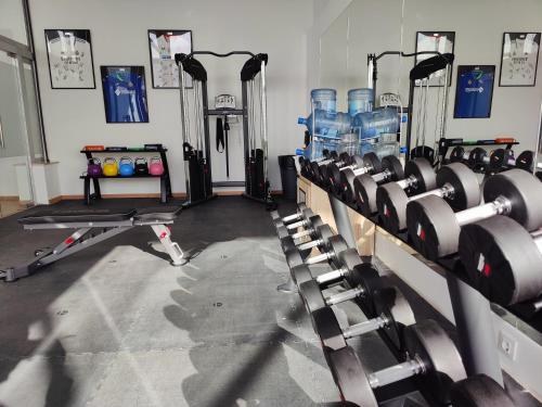 a gym with several rows of machines in a room at Cabogata Beach Hotel in Retamar
