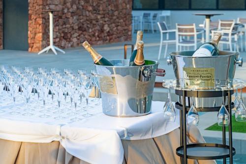 a table with glasses and bottles of champagne in an ice bucket at Cabogata Beach Hotel in Retamar