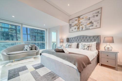 a bedroom with a large bed and a window at The Marina PENTHOUSE near JBR 46th Floor in Dubai