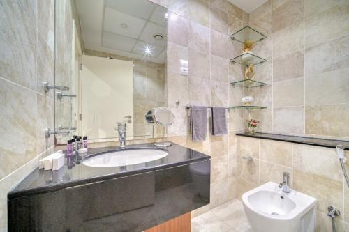 a bathroom with a sink and a toilet at The Marina PENTHOUSE near JBR 46th Floor in Dubai