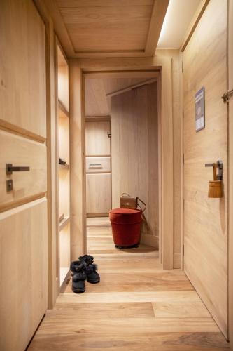 a hallway with a red tub and shoes on the floor at Armancette - The Leading Hotels of the World in Saint-Gervais-les-Bains