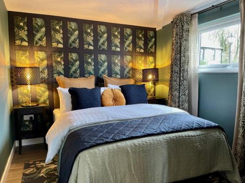 a bedroom with a large bed and two lamps at The Cabin@TyddynUcha in Caernarfon