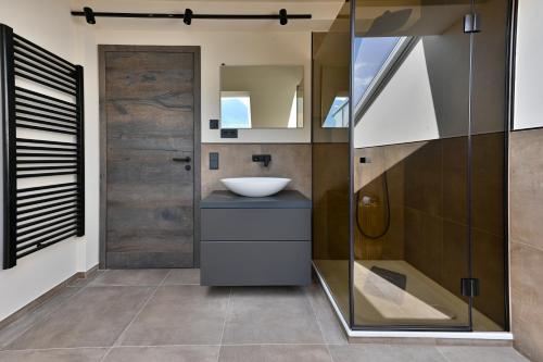 a bathroom with a sink and a glass door at BergChalet in Garmisch-Partenkirchen