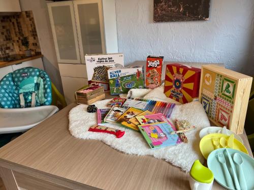 a table topped with lots of toys and books at Refuge du Loup in Virton