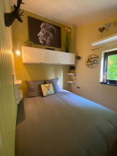 a bedroom with a large bed in a room at Refuge du Loup in Virton