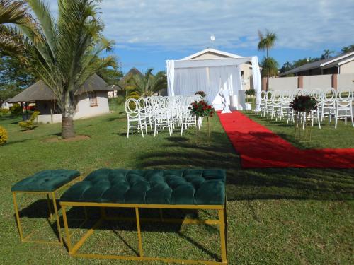 a group of white chairs and a red carpet at Noma-Nini Lodge in White River