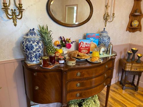 a wooden dresser with food on top of it at Jeffrey’s B and B 