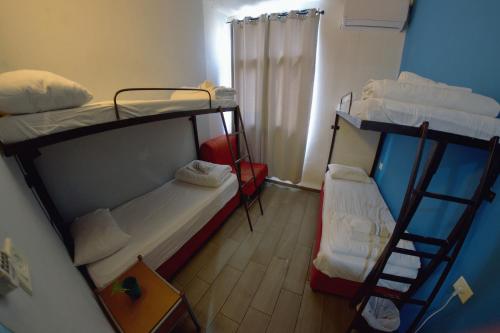 a small room with two bunk beds in it at Tiberias Hostel in Tiberias