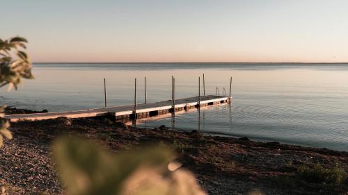 a dock in the middle of a body of water at Stora Frögården in Mörbylånga