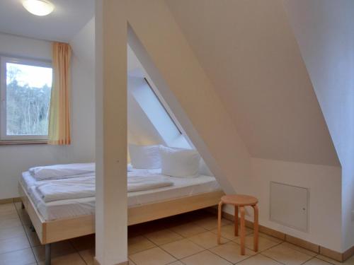 a bedroom with a bed under the stairs at Ferienwohnung NH14 in Hirschburg