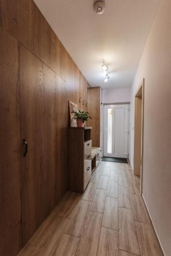 an empty hallway with wood paneling and a door at Beverly Hills House pri potoku by Pinkreal in Solčany