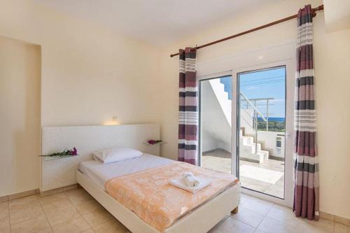 une chambre avec un lit avec vue sur l'océan dans l'établissement Pearl Villas Gennadi, à Gennadi