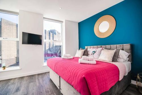 a bedroom with a large bed with a pink blanket at Apartment 3 - The Crescent in York