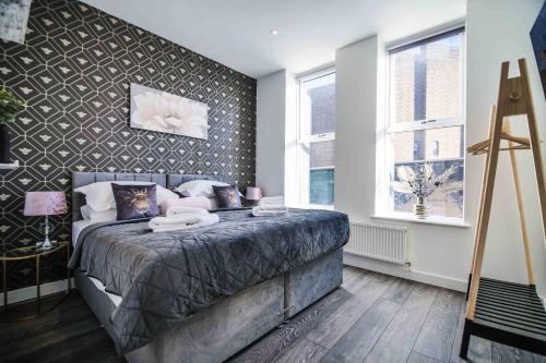 a bedroom with a bed and a wall at Apartment 2 - The Crescent in York