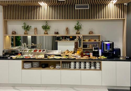 a kitchen with a counter with food on it at Hotel Sebory in Przasnysz