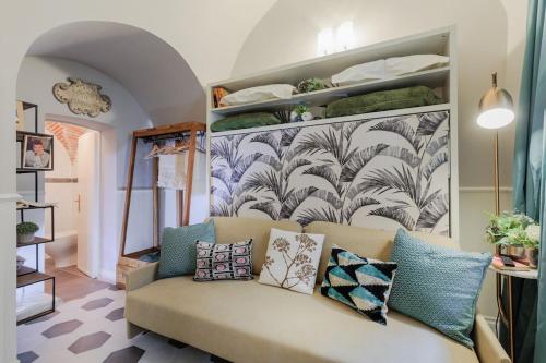 un soggiorno con divano e cuscini sopra di Busdraghi Studio, a stylish studio along Via Fillungo a Lucca