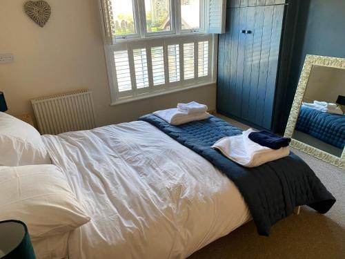 a bedroom with a bed with towels on it at Lychgate view cottage in Aldbrough