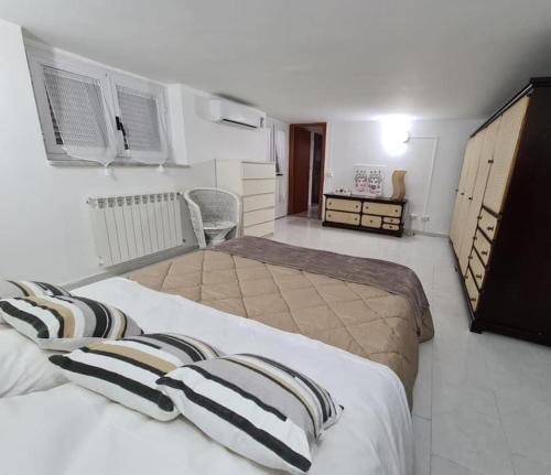 a hotel room with two beds and a bathroom at Capogallo47 in Mondello