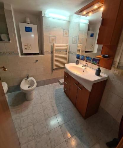 a bathroom with a sink and a toilet at Capogallo47 in Mondello