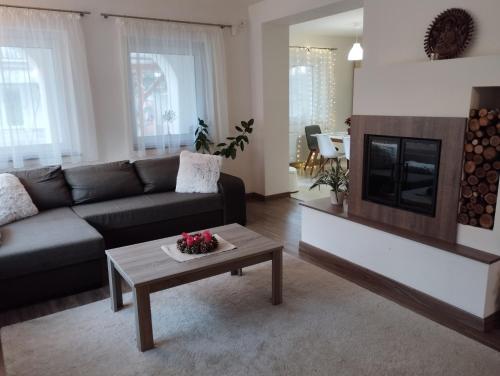a living room with a couch and a coffee table at Életvirág Rezidencia és Vendéglak in Egerszalók