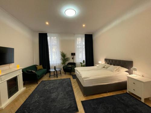 a bedroom with a bed and a living room at Fullmoon Luxury Apartment in Szeged