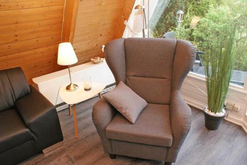 a living room with a chair and a lamp at wenige Meter bis zum Strand in Damp