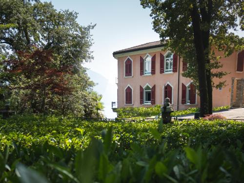 una mujer parada frente a un edificio en Hotel Monte Verità, en Ascona