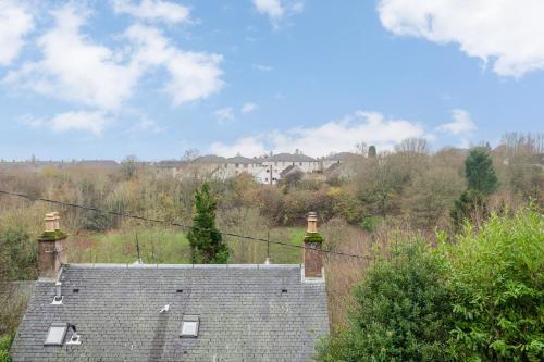 a roof of a house with a building in the background at Glengate - Traditional home in Kirriemuir in Kirriemuir