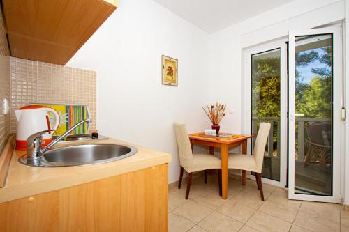 una cucina con un lavello e un tavolo di Villa Bianca a Trogir