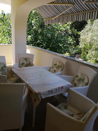 a table and chairs sitting on a balcony at Apartment Marina in Punat