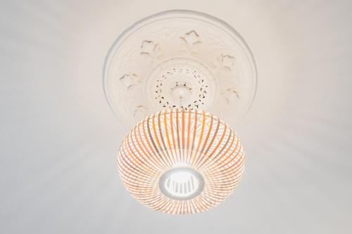 a ceiling light with a white and orange at Glengate - Traditional home in Kirriemuir in Kirriemuir