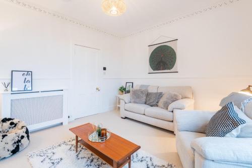 a living room with two couches and a coffee table at Glengate - Traditional home in Kirriemuir in Kirriemuir