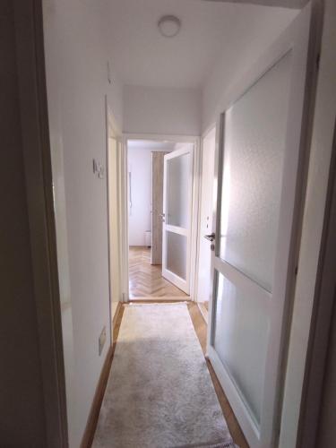 an empty hallway with an open door to a room at Apartman Olga in Trebinje