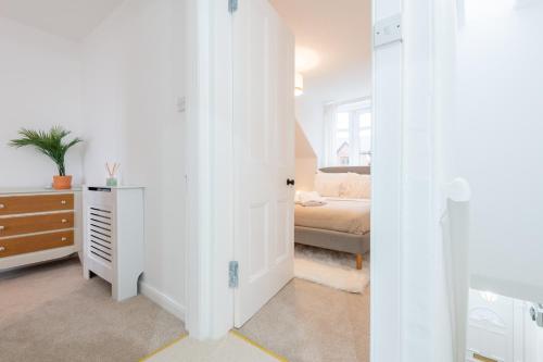 a white room with a bedroom with a bed at Glengate - Traditional home in Kirriemuir in Kirriemuir