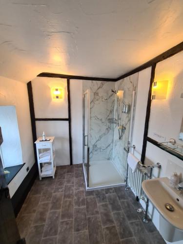 a bathroom with a shower and a sink at Lane Head Farm Country Guest House in Troutbeck