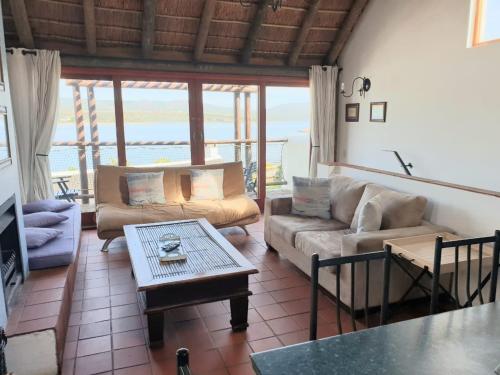 a living room with a couch and a table at Breede River Lodge in Witsand