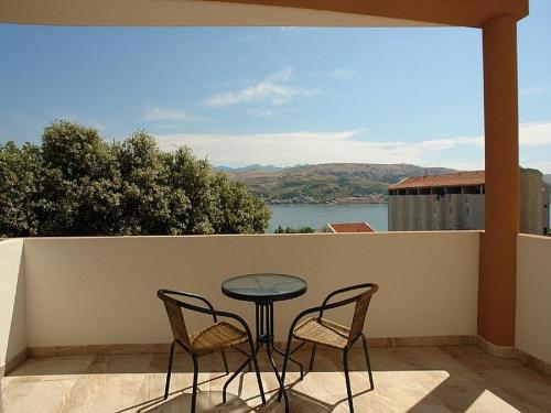 a table and two chairs on a balcony with a view at Pansion Jurko in Pag