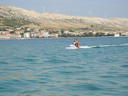 a man on a jet ski in the water at Pansion Jurko in Pag