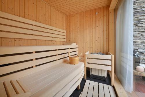 a sauna with wood paneled walls and benches at Hotel Morris Premium Collection in Česká Lípa