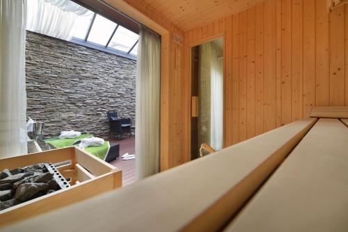 a room with wooden walls and a large window at Hotel Morris Premium Collection in Česká Lípa