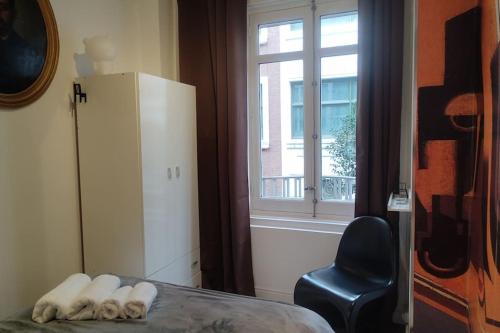 a room with a bed and a chair and a window at Madrid Centro, Edificio Entero Solo Para Ti in Madrid