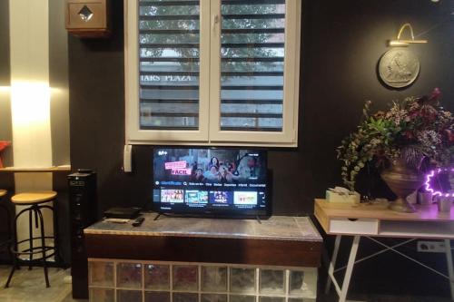 a tv sitting on top of a table in a room at Madrid Centro, Edificio Entero Solo Para Ti in Madrid
