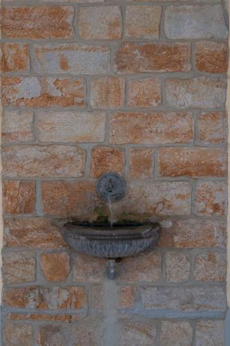 a stone wall with a fountain in a brick wall at Hofgarten 1824 Hotel garni in Dresden