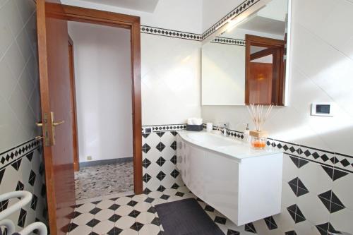a bathroom with a sink and a mirror at Appartamento Dei Ronchi in Marina di Massa