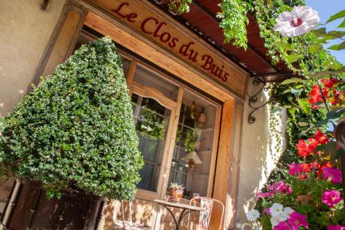 a shop with a christmas tree in front of it at Le Clos Du Buis in Bonnieux