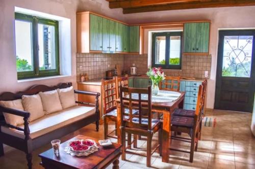 a living room with a couch and a table at Villa Andreas-Dimitris in Volimes