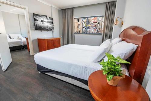 a hotel room with a bed and a table at Spirit of Herzl Hotel in Jerusalem